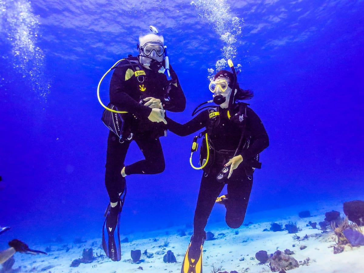 Judy Rohlin scuba diving underwater alongside her husband Robert